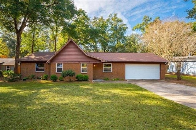 ranch-style house with a garage, a front yard, and concrete driveway