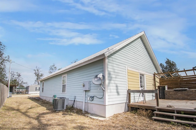 view of home's exterior featuring cooling unit and a deck