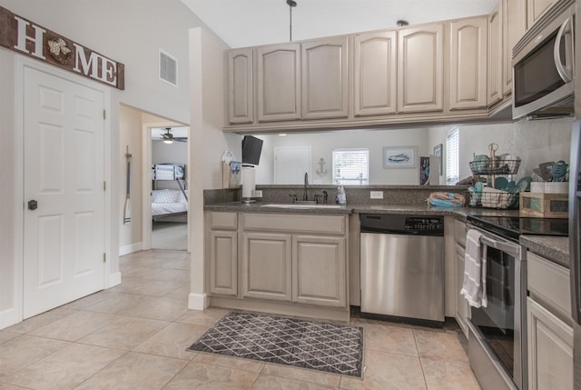 kitchen featuring sink, stainless steel appliances, ceiling fan, and light tile patterned flooring