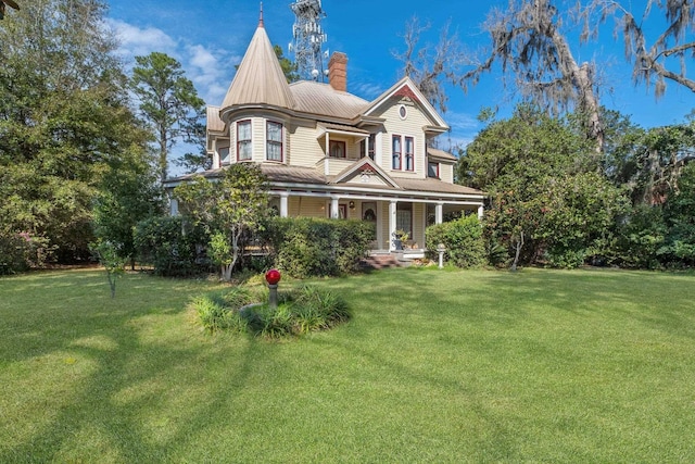 victorian house with covered porch and a front lawn