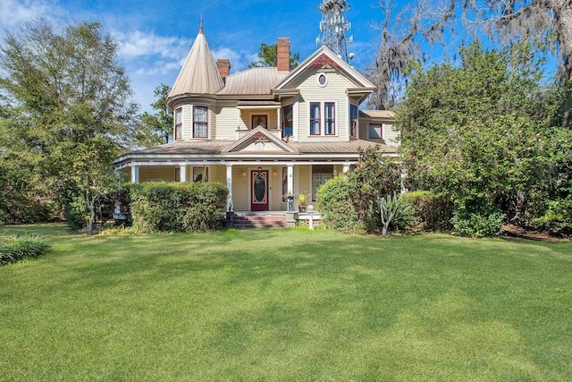 victorian house with a front yard and a porch