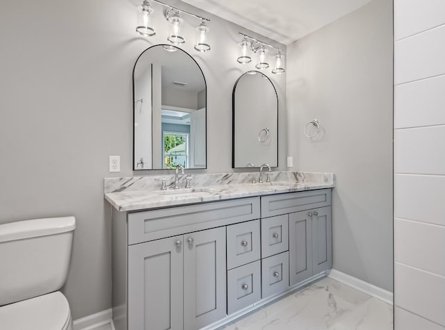 bathroom featuring toilet and vanity