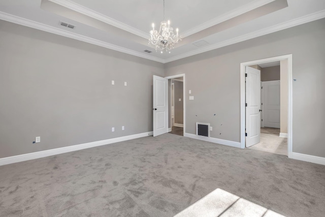 unfurnished bedroom featuring carpet, visible vents, and a tray ceiling
