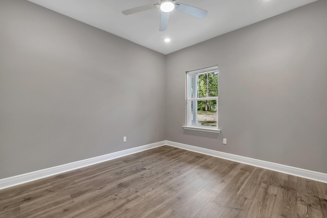 spare room featuring baseboards, recessed lighting, wood finished floors, and ceiling fan