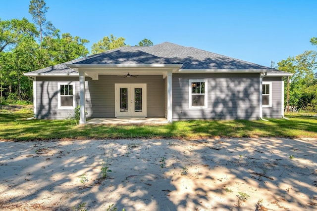 rear view of property featuring a patio, ceiling fan, a shingled roof, and french doors