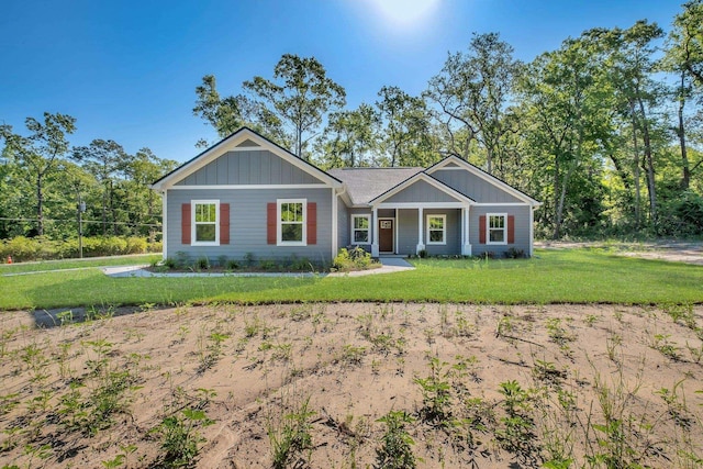 craftsman inspired home featuring a front yard and board and batten siding