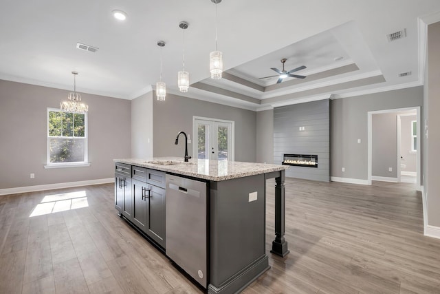 kitchen featuring visible vents, ceiling fan with notable chandelier, dishwasher, and a sink