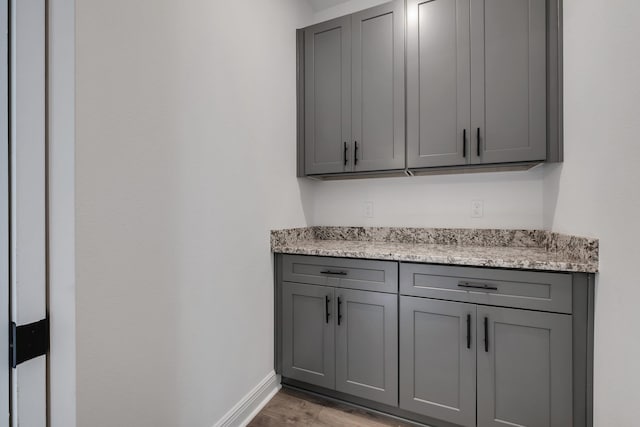 bar with baseboards and light wood-style floors