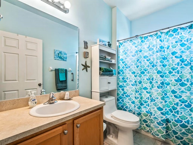 bathroom with toilet, vanity, tile patterned flooring, and walk in shower