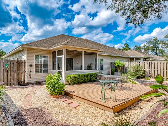 rear view of house featuring a wooden deck