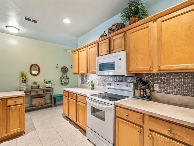 kitchen featuring white appliances, light tile patterned floors, and decorative backsplash