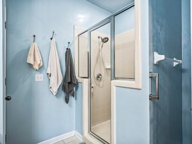 bathroom with tile patterned flooring and an enclosed shower