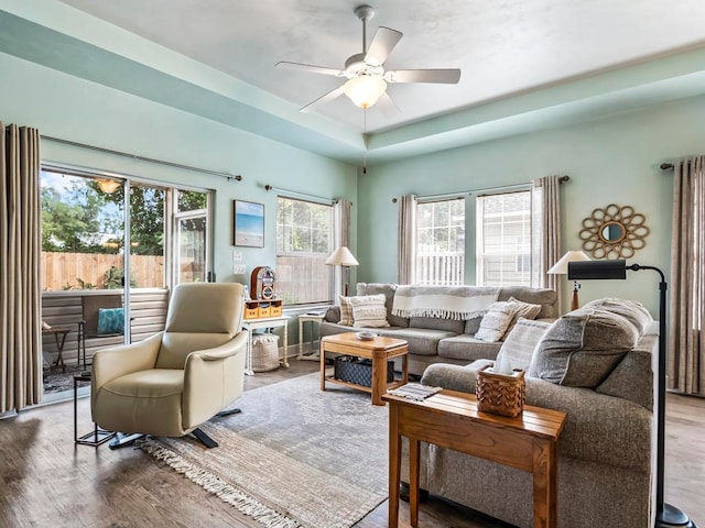 living room with hardwood / wood-style flooring, ceiling fan, and a wealth of natural light