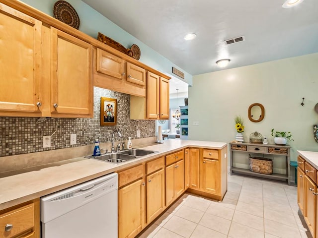 kitchen featuring light tile patterned flooring, sink, kitchen peninsula, backsplash, and dishwasher