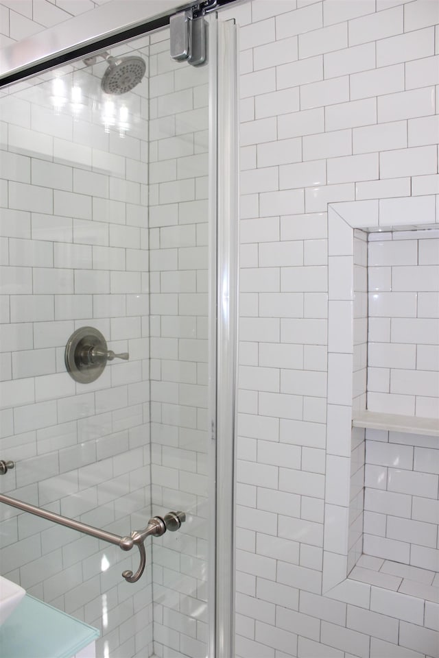 bathroom with a shower with door