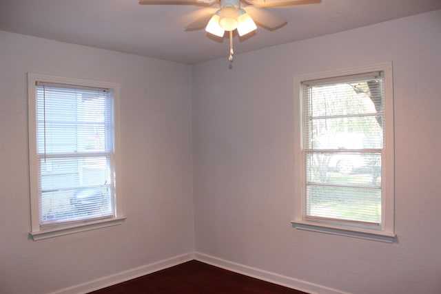 empty room featuring ceiling fan and dark wood-type flooring