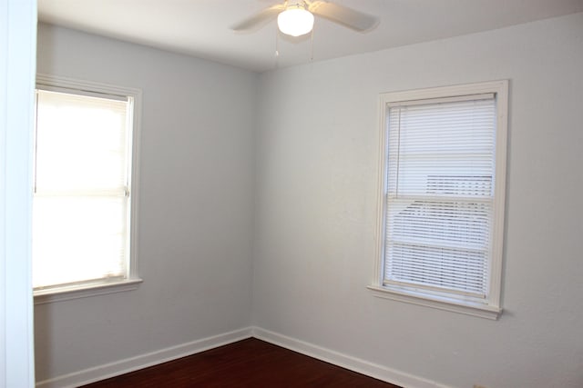 spare room featuring dark hardwood / wood-style floors and ceiling fan