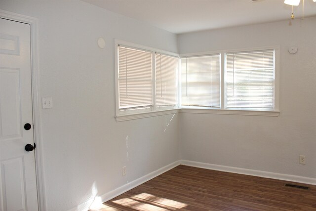 unfurnished room featuring dark hardwood / wood-style flooring and ceiling fan