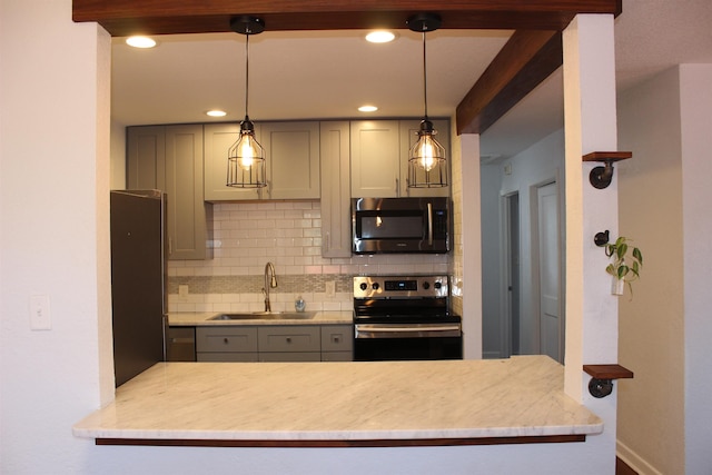 kitchen featuring hanging light fixtures, sink, gray cabinets, appliances with stainless steel finishes, and tasteful backsplash