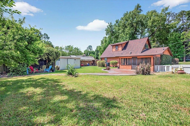 6847 Donerail Trl, Tallahassee, FL 32309 - view of yard with a sunroom, a patio, an outdoor structure, and a storage unit