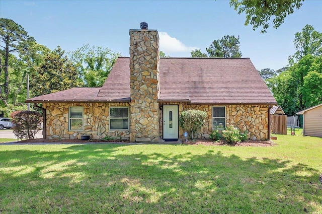 6847 Donerail Trl, Tallahassee, FL 32309 - english style home with stone siding, a chimney, a front lawn, and a shingled roof