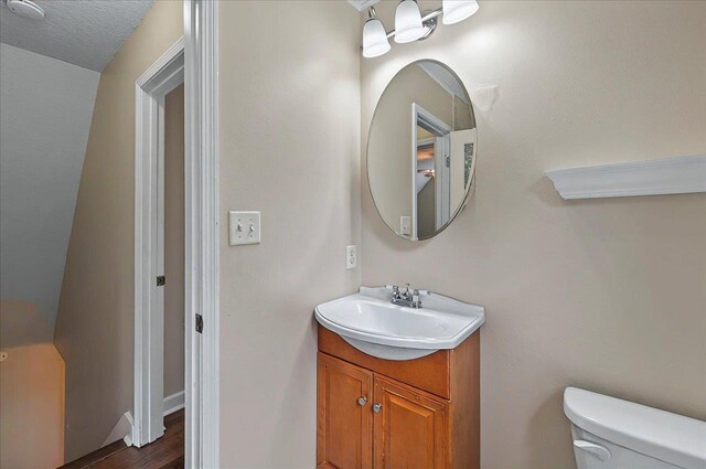 6847 Donerail Trl, Tallahassee, FL 32309 - bathroom featuring toilet, vanity, and wood finished floors