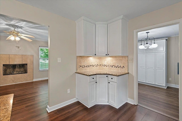 6847 Donerail Trl, Tallahassee, FL 32309 - kitchen featuring dark wood-style flooring, white cabinetry, light stone counters, tasteful backsplash, and a ceiling fan
