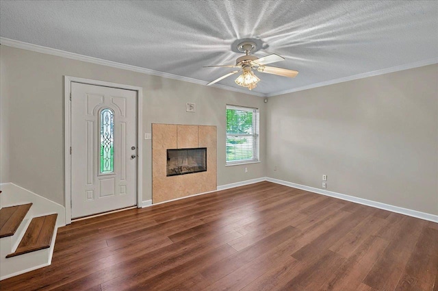 6847 Donerail Trl, Tallahassee, FL 32309 - unfurnished living room with a tiled fireplace, wood finished floors, ceiling fan, stairs, and a textured ceiling