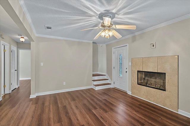 6847 Donerail Trl, Tallahassee, FL 32309 - foyer entrance with wood finished floors, a ceiling fan, a tile fireplace, baseboards, and ornamental molding