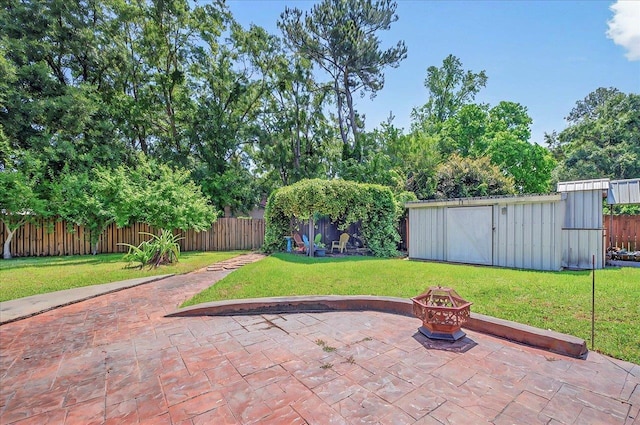 6847 Donerail Trl, Tallahassee, FL 32309 - view of patio / terrace with a fire pit, an outbuilding, and a storage unit