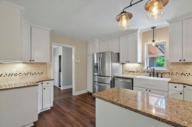 6847 Donerail Trl, Tallahassee, FL 32309 - kitchen featuring stainless steel appliances, a sink, baseboards, and backsplash