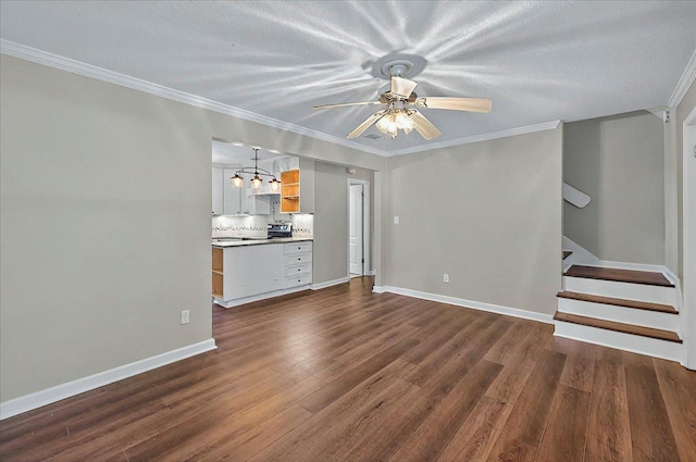 6847 Donerail Trl, Tallahassee, FL 32309 - unfurnished living room featuring dark wood-type flooring, ceiling fan, crown molding, stairs, and baseboards