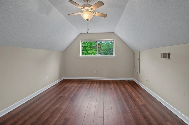6847 Donerail Trl, Tallahassee, FL 32309 - additional living space featuring a textured ceiling, dark wood-type flooring, ceiling fan, baseboards, and vaulted ceiling