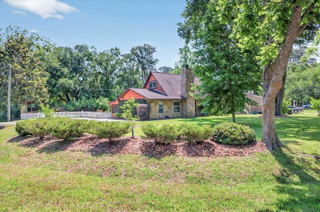 6847 Donerail Trl, Tallahassee, FL 32309 - view of front of property with stone siding, a chimney, and a front yard