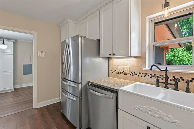 6847 Donerail Trl, Tallahassee, FL 32309 - kitchen with appliances with stainless steel finishes, a sink, dark wood-style flooring, white cabinets, and tasteful backsplash