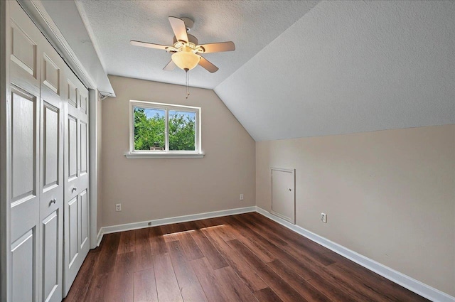 6847 Donerail Trl, Tallahassee, FL 32309 - additional living space with ceiling fan, a textured ceiling, dark wood-style floors, lofted ceiling, and baseboards