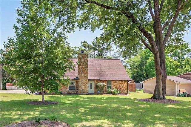 6847 Donerail Trl, Tallahassee, FL 32309 - view of front of house with stone siding, a front yard, and a chimney