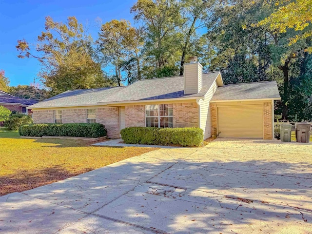 single story home with a garage and a front yard