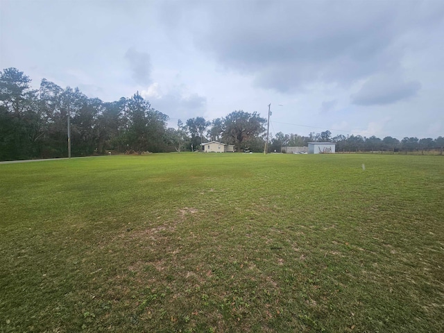 view of yard with a rural view