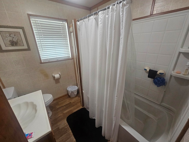 full bathroom featuring shower / bath combination with curtain, hardwood / wood-style floors, vanity, toilet, and tile walls