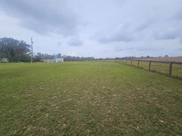 view of yard with a rural view