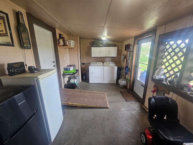 laundry room featuring washing machine and dryer and cabinets