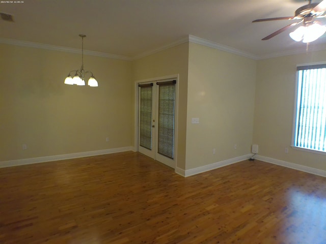 unfurnished room featuring wood-type flooring, ceiling fan with notable chandelier, and crown molding