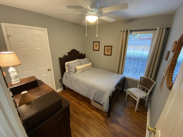 bedroom featuring ceiling fan, baseboards, and dark wood-type flooring