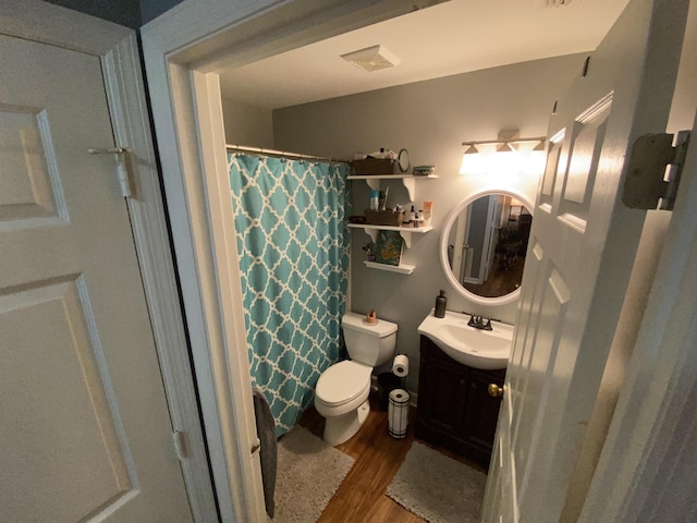 full bath featuring visible vents, toilet, vanity, wood finished floors, and a shower with curtain