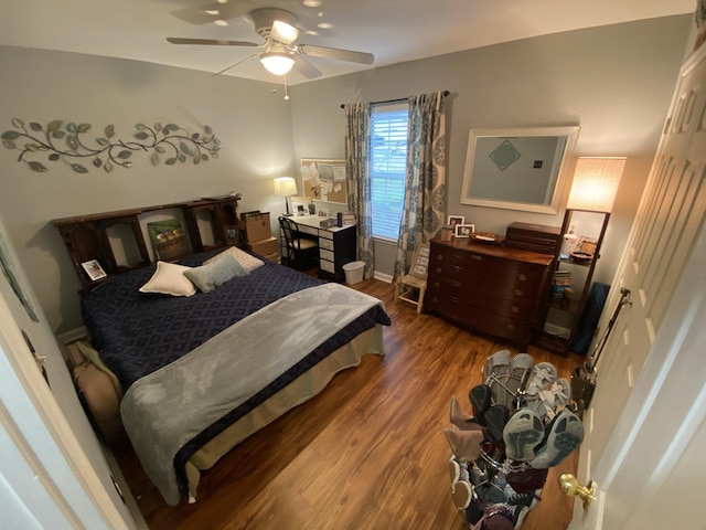 bedroom with dark wood-type flooring, baseboards, and a ceiling fan