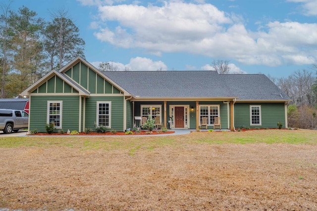 view of front of home with a front yard and a porch