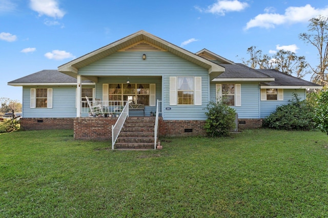 rear view of property with a yard, a porch, crawl space, and roof with shingles