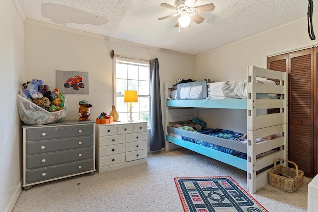 carpeted bedroom with ornamental molding, a textured ceiling, and a ceiling fan