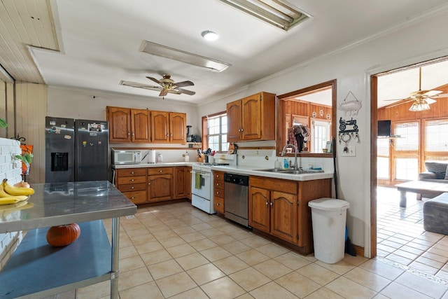 kitchen featuring white appliances, brown cabinets, a sink, crown molding, and backsplash